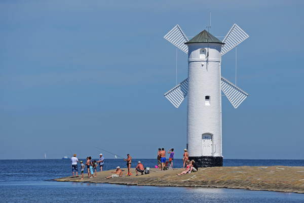 Windmühle und Badegäste am Wasser